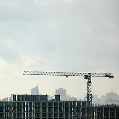 Image showing Panoramic photo from the drone of building under construction with crane against a cloudy sky.