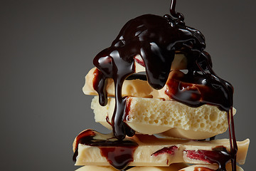 Image showing syrop pouring onto a piece of chocolate