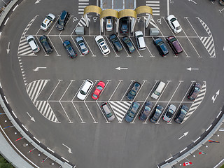 Image showing Birds eye view from the drone is strictly above the parking with cars.