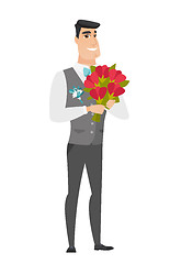 Image showing Caucasian groom holding a bouquet of flowers