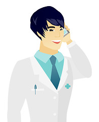 Image showing Young asian doctor talking on a mobile phone.