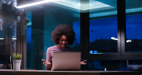 Image showing black businesswoman using a laptop in night startup office