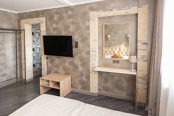 Image showing Fragment of the interior of a one-room apartment with a TV and dressing table
