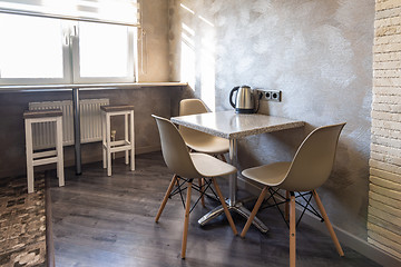 Image showing A table with chairs in the interior of the kitchen