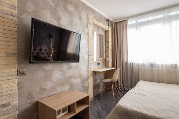 Image showing Interior of a bedroom, a fragment with a TV and a dressing table