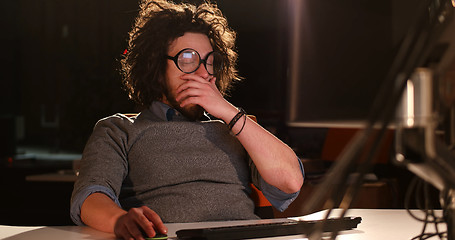 Image showing man working on computer in dark office