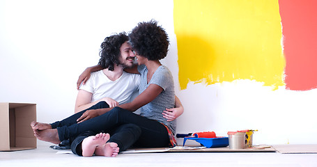 Image showing young multiethnic couple relaxing after painting