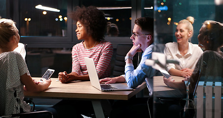 Image showing Multiethnic startup business team in night office