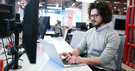 Image showing businessman working using a laptop in startup office