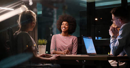 Image showing Multiethnic startup business team in night office