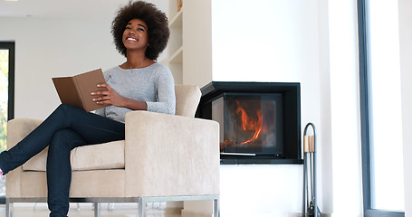 Image showing black woman at home reading book