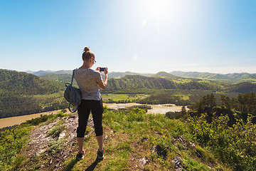 Image showing Woman taking photo in mountain