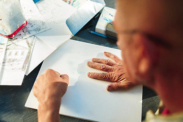 Image showing Close up man working of Architect sketching a construction project on his plane project at site construction work