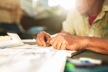 Image showing Close up man working of Architect sketching a construction project on his plane project at site construction work