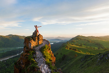 Image showing Man standing on top of cliff