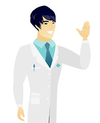 Image showing Young asian doctor waving his hand.