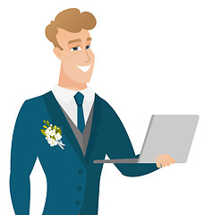Image showing Young caucasian groom using a laptop.