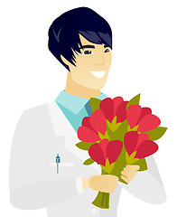 Image showing Young asian doctor holding a bouquet of flowers.