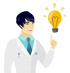 Image showing Young asian doctor pointing at idea light bulb.
