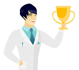 Image showing Young asian doctor holding a golden trophy.