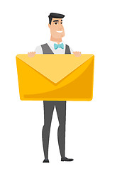 Image showing Smiling groom holding a big envelope.