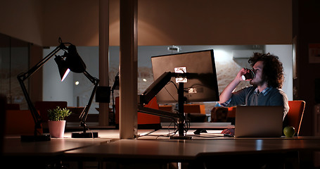 Image showing Tired businessman working late
