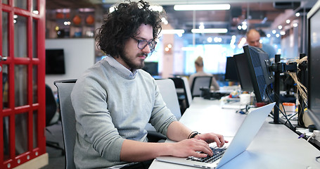 Image showing businessman working using a laptop in startup office