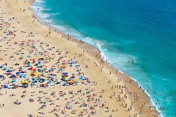 Image showing Crowded ocean beach. Nazare, Portugal