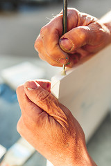 Image showing Close up man working of Architect sketching a construction project on his plane project at site construction work