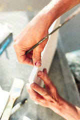 Image showing Close up man working of Architect sketching a construction project on his plane project at site construction work