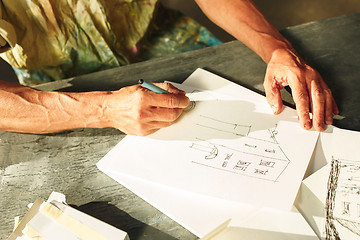 Image showing Close up man working of Architect sketching a construction project on his plane project at site construction work