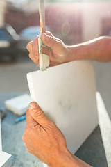 Image showing Close up man working of Architect sketching a construction project on his plane project at site construction work