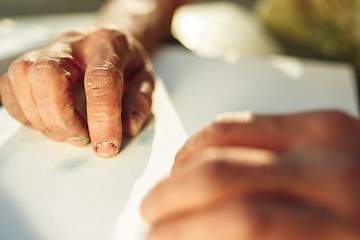 Image showing Close up man working of Architect sketching a construction project on his plane project at site construction work