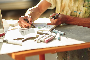 Image showing Close up man working of Architect sketching a construction project on his plane project at site construction work