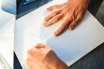 Image showing Close up man working of Architect sketching a construction project on his plane project at site construction work