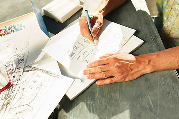 Image showing Close up man working of Architect sketching a construction project on his plane project at site construction work