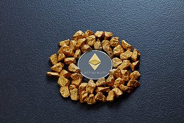 Image showing Etereum coin and golden nuggets on a black concrete background. Business, finance and technology concept.