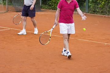 Image showing Doubles tennis player with partner in the background