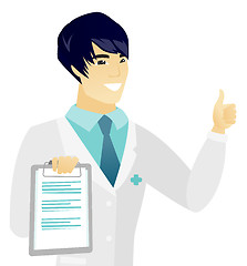 Image showing Young asian doctor with clipboard giving thumb up.