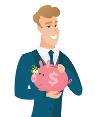 Image showing Caucasian groom holding a piggy bank.