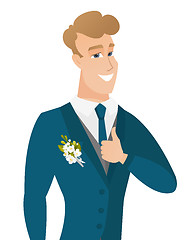 Image showing Young caucasian groom giving thumb up.