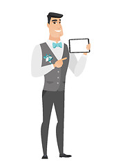 Image showing Smiling groom holding tablet computer.