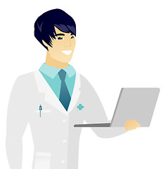 Image showing Young asian doctor using a laptop.