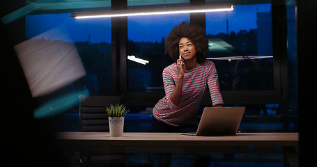 Image showing black businesswoman using a laptop in night startup office