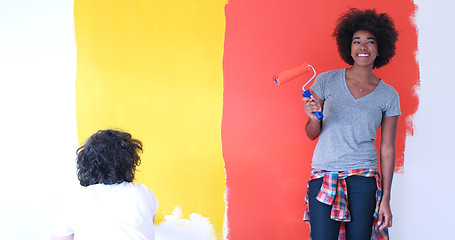 Image showing multiethnic couple painting interior wall