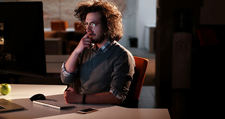 Image showing man working on computer in dark office