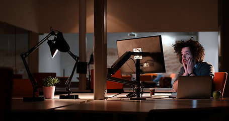 Image showing man working on computer in dark office