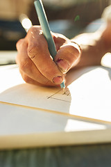 Image showing Close up man working of Architect sketching a construction project on his plane project at site construction work