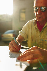 Image showing Close up man working of Architect sketching a construction project on his plane project at site construction work