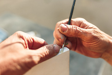 Image showing Close up man working of Architect sketching a construction project on his plane project at site construction work